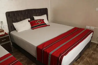 a bed with two pillows on it in a room at Premium apartment Section A in Wadi Musa