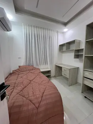 a bedroom with a large bed and a desk at Nice place in Irbid