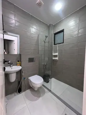 a bathroom with a toilet and a sink and a shower at Nice place in Irbid