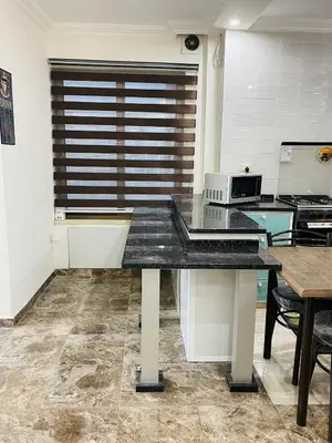 a kitchen with a table with a counter top at New studio in Jabal Amman and Al-Weibdeh متابعة in Amman