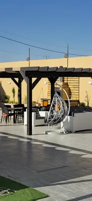 a pavilion with a picnic table and a playground at شاليه المهرة in Murayjimat Ibn Ḩāmid