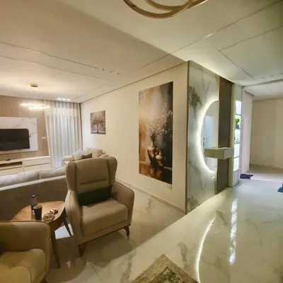 a living room with a couch and a chair at Cozy 3BR Apartment by 7th Circle in Amman