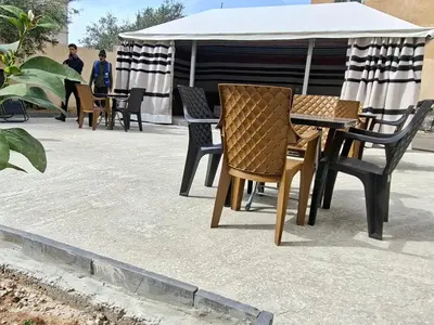 a group of chairs and tables on a patio at Jeeso Hotel in Jerash