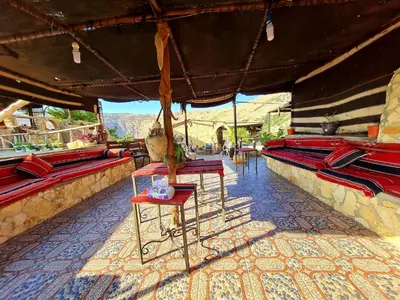 a group of chairs and tables on a patio at TOWER Hotel in Dana