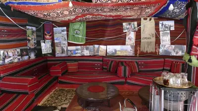 a bar with red couches and a table at TOWER Hotel in Dana
