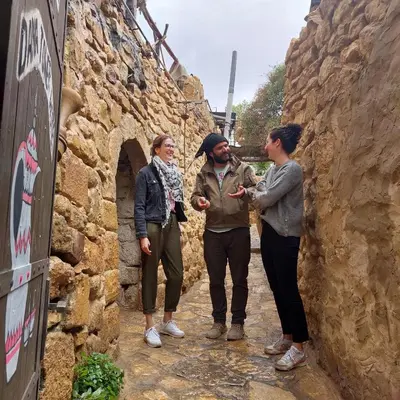 a group of three people standing in an alley at TOWER Hotel in Dana