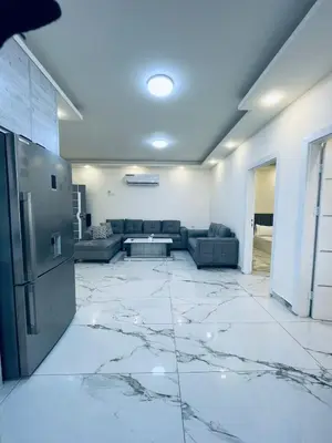 a living room with a large marble floor at Zurich Furnished Apartments in Al Mafraq