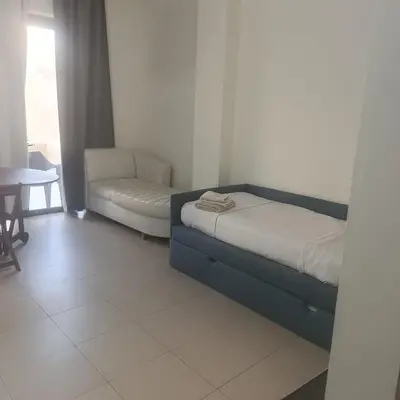 a bedroom with a bed and a couch and a chair at Family WeekEnds Getaways at Samarah Resort Studio in Sowayma
