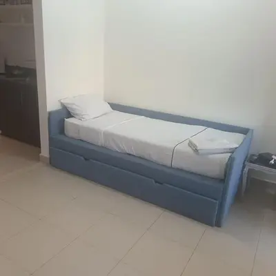 a bed with a blue frame in a room at Family WeekEnds Getaways at Samarah Resort Studio in Sowayma