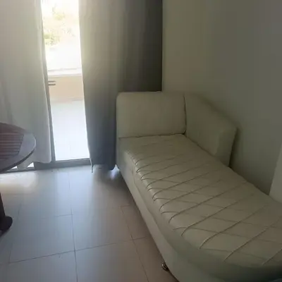 a white couch in a room with a window at Family WeekEnds Getaways at Samarah Resort Studio in Sowayma