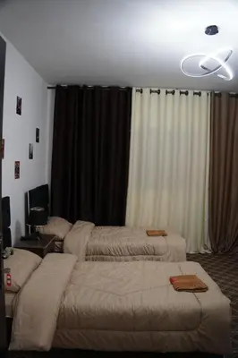 a bedroom with two beds in front of a window at Petra entrance Apartment in Petra