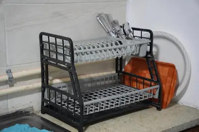 a metal dish rack with utensils on a shelf at Petra entrance Apartment in Petra