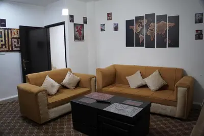 a living room with two couches and a coffee table at Petra Visitor Center Apartment in Petra