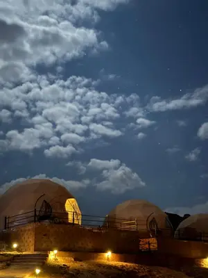 a group of domes in the desert at night at Gmal Rum Cano in Wadi Rum