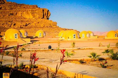 a view of a desert with a group of buildings at وادي رم in Wadi Rum