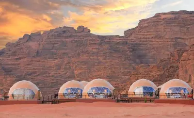 a painting of three domes in front of a mountain at وادي رم in Wadi Rum