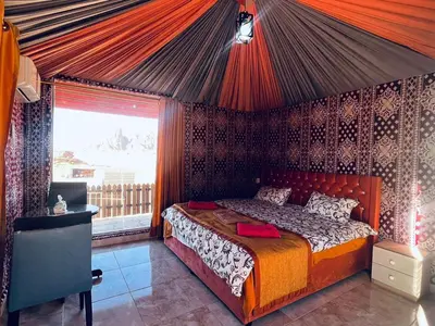 a bedroom with a bed in a tent at LAVRA lUXURY CAMP in Wadi Rum