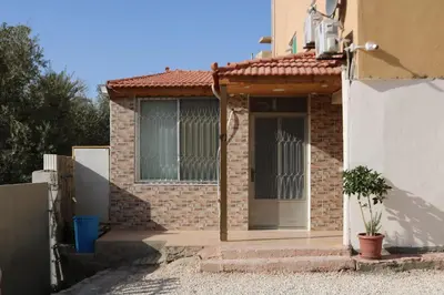 a brick house with a door and a window at PetraEcho lodge Section B Home in Wadi Musa