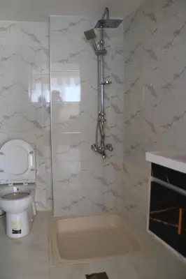 a bathroom with a toilet and a bath tub at PetraEcho lodge Section B Home in Wadi Musa