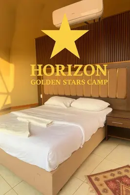 a hotel room with a bed with a star on the wall at Horizon Star Golden Camp in Wadi Rum