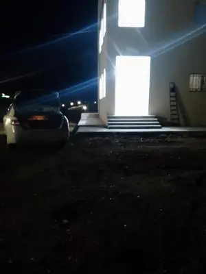 a car parked in front of a building at night at The Fog mountain in Kerak