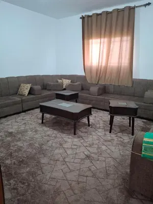 a living room with a couch and two tables at The Fog mountain in Kerak