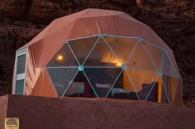 a large tent with a window on top of a wall at Wadi Rum in Al Jafr