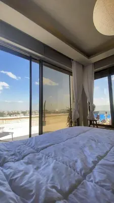 a bedroom with a bed with a view of the beach at Doctor roof in Amman