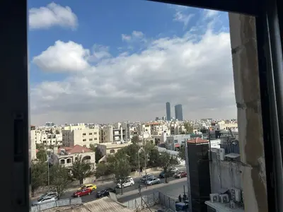 a view of a city from a window at A double bed apartment in heart of Amman شارع سلطان الهند خلف ش عبدالله غوشه in Amman