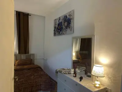 a bedroom with a bed and a mirror at A double bed apartment in heart of Amman شارع سلطان الهند خلف ش عبدالله غوشه in Amman