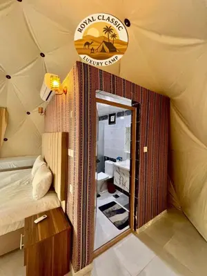 a room with a tent with a bed and a mirror at RUM ROYAL CLASSIC lUXURY CAMP in Disah