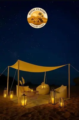 a tent on the beach at night with lights at RUM ROYAL CLASSIC lUXURY CAMP in Disah