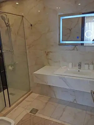 a bathroom with a shower and a sink at شقه مفروشه in Amman