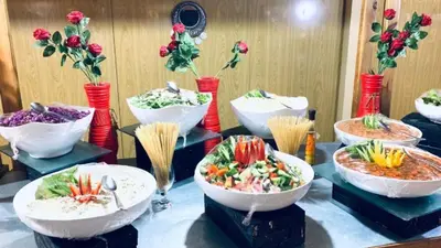a table topped with bowls of different types of food at moon and sky camp in Wadi Rum
