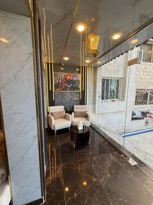 a lobby with two chairs and a table at Al-Farouq Suites in Amman