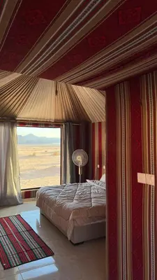 a bedroom with a bed and a large window at Milky Way Galaxy Camp in Disah