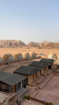 a group of buildings in a desert with domes at Al-Najm Coastal Camp Rum in Wadi Rum