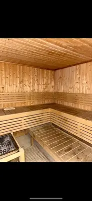 an empty sauna with wooden walls and wooden floors at DAMAC Tower Amman boulevard برج داماك - عمان البوليفارد العبدلي in Amman