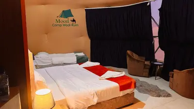 a room with a bed with a sign on it at Moon Camp Wadi Rum in Wadi Rum