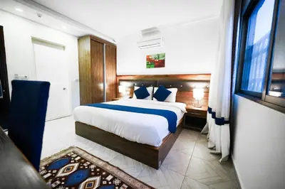 a bedroom with a large bed and a window at Corner View Hotel in Wadi Musa