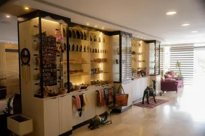 a store with a display of shoes on the wall at Corner View Hotel in Wadi Musa