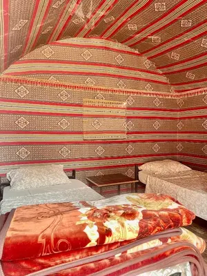 a bedroom with a bed in a room with a ceiling at Wadi Rum Bedouin Life in Wadi Rum