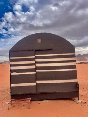 a large metal object in the middle of the desert at Wadi Rum Bedouin Life in Wadi Rum