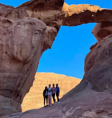 a group of people standing in a rock formation at Wadi Rum Bedouin Life in Wadi Rum