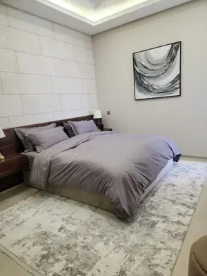 a bedroom with a large bed in a white room at كمباوند المطار شقه مفروشة in Amman