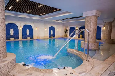 a pool in a hotel with a water fountain at كمباوند المطار شقه مفروشة in Amman