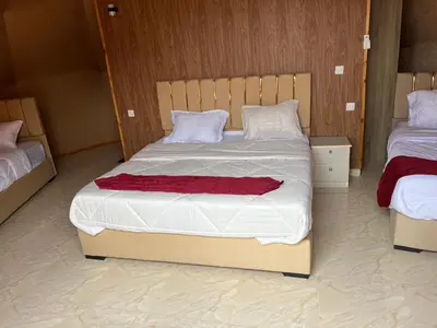 a bedroom with two beds with white and red sheets at Wadi Rum Star Haven camp in Wadi Rum