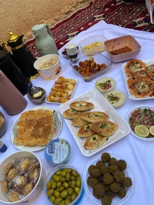 a table topped with lots of different types of food at Wadi Rum Star Haven camp in Wadi Rum