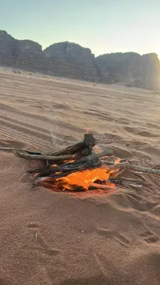 a bonfire on the beach in the sand at Wadi Rum Star Haven camp in Wadi Rum