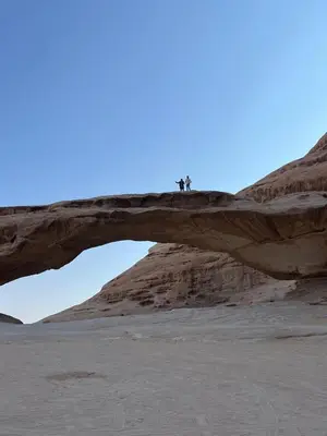 two people standing on a bridge in the desert at Wadi Rum Star Haven camp in Wadi Rum